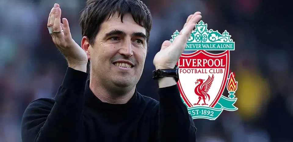 Coach applauding with Liverpool FC logo in background