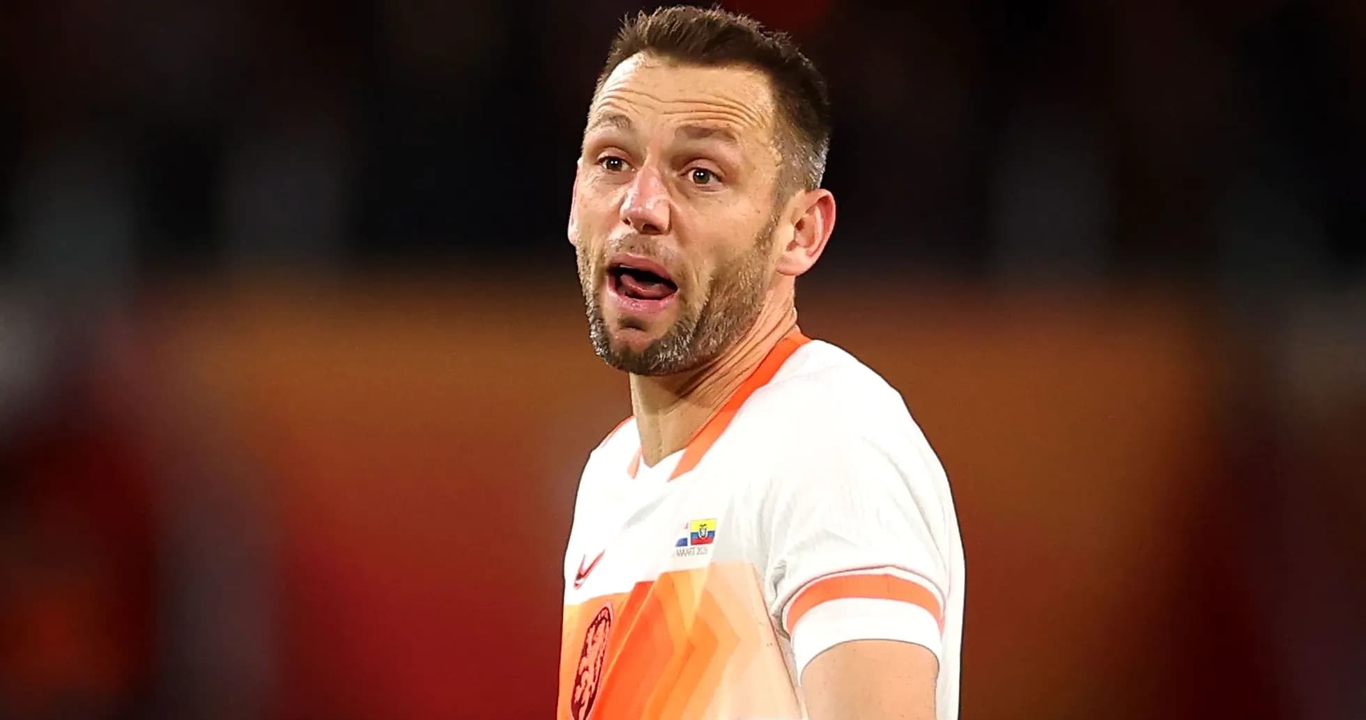 Player wearing orange jersey during match action