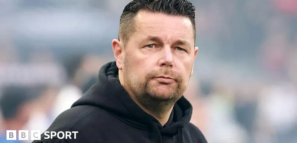 Coach looking on during a match at stadium