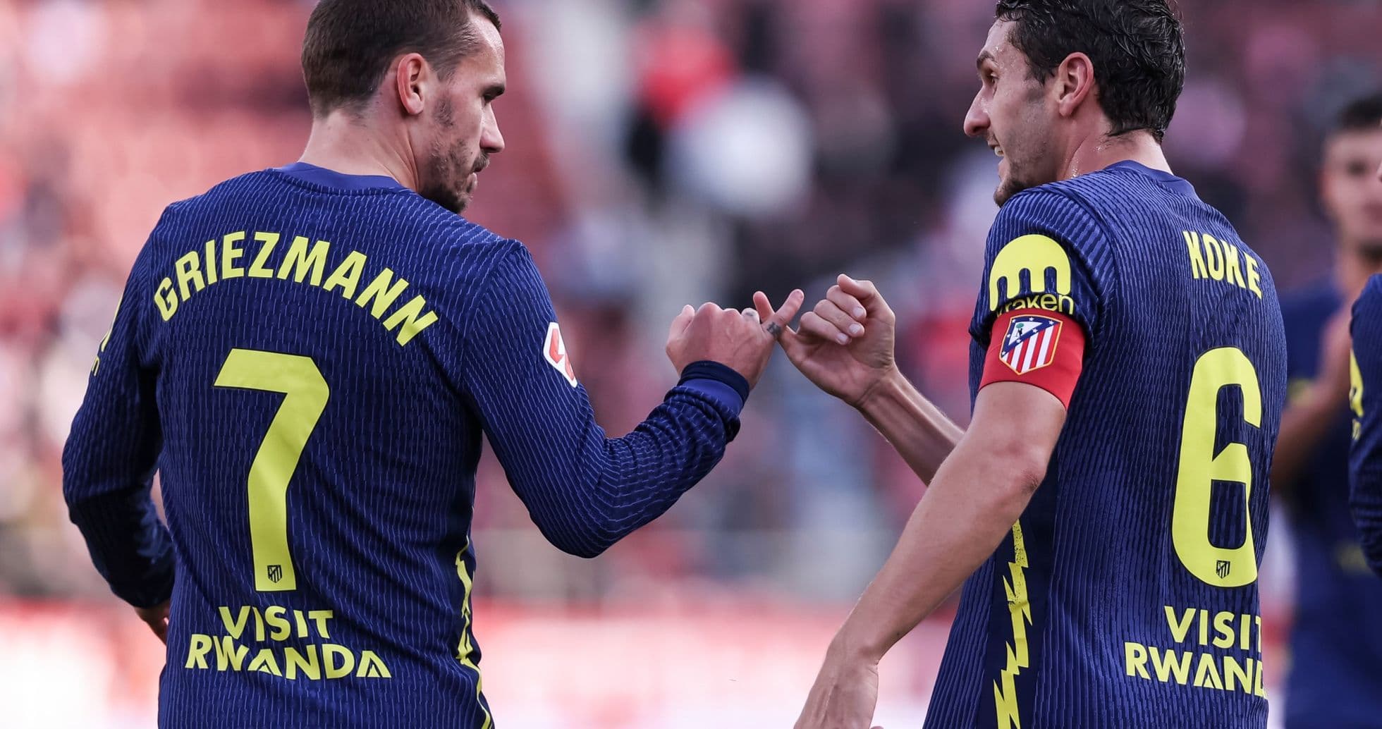 Griezmann and Koke celebrating on the pitch