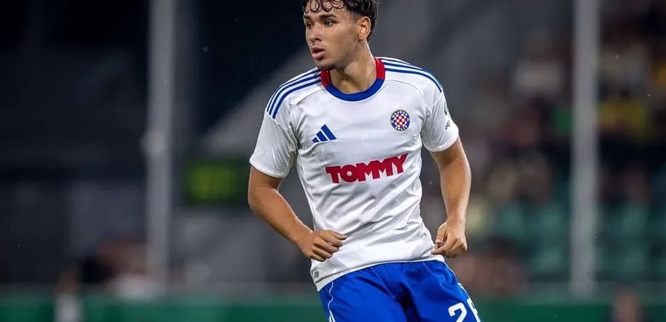 Player in action wearing a white and blue kit