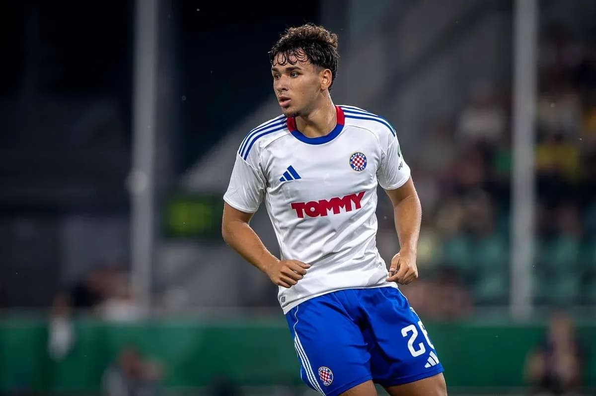 Player in action wearing a white and blue kit