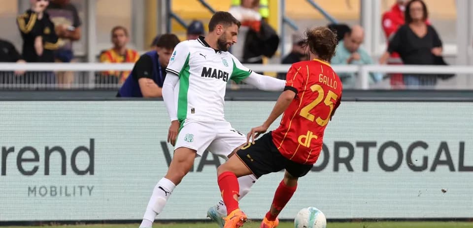 Sassuolo player tackling Lecce opponent