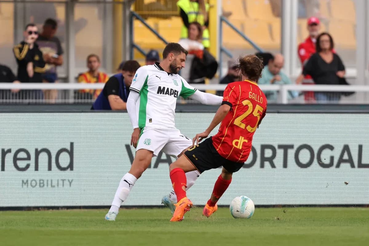 Sassuolo player tackling Lecce opponent
