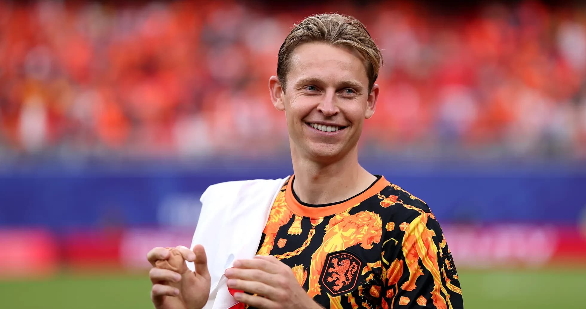 Player in colorful jersey smiling on the pitch