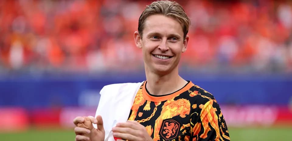 Player in colorful jersey smiling on the pitch