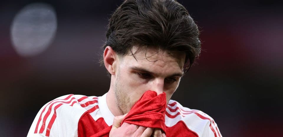 Player holding shirt to face in disappointment