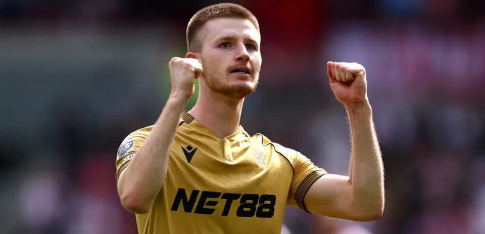 Player celebrating with clenched fists on pitch