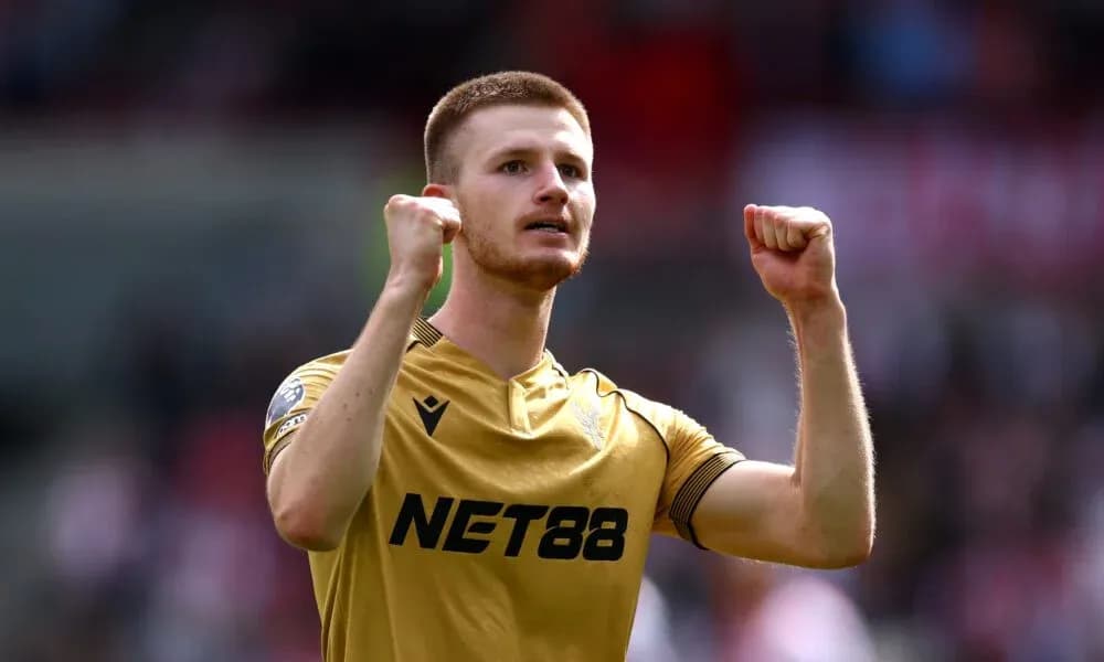 Player celebrating with clenched fists on pitch