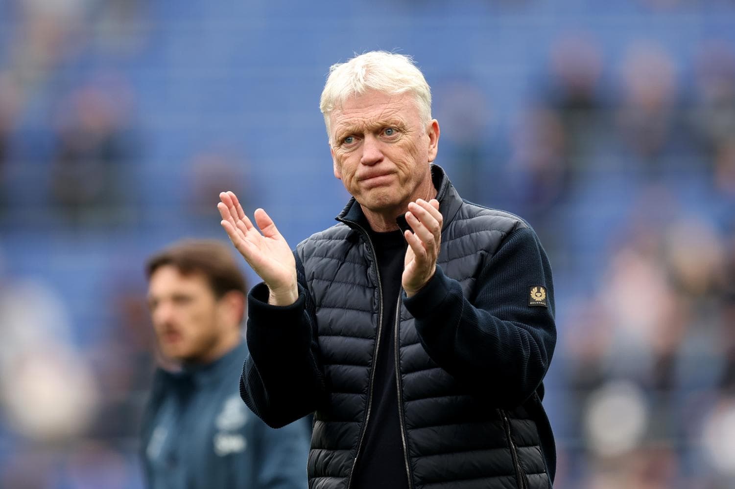 Manager clapping during match on the sidelines