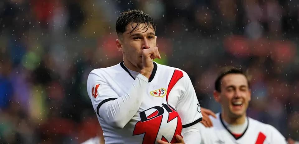 Player celebrating with finger to lips, rain falling