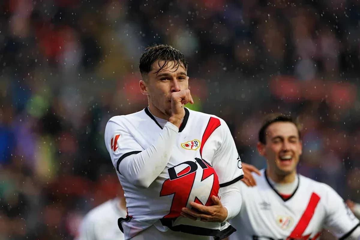 Player celebrating with finger to lips, rain falling