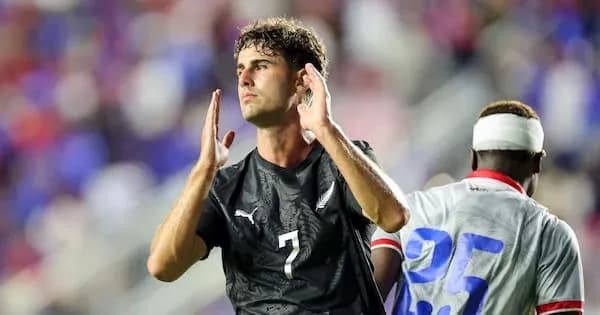 Player in black jersey gesturing during match