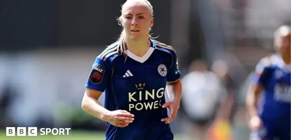 Female player running in Leicester City kit