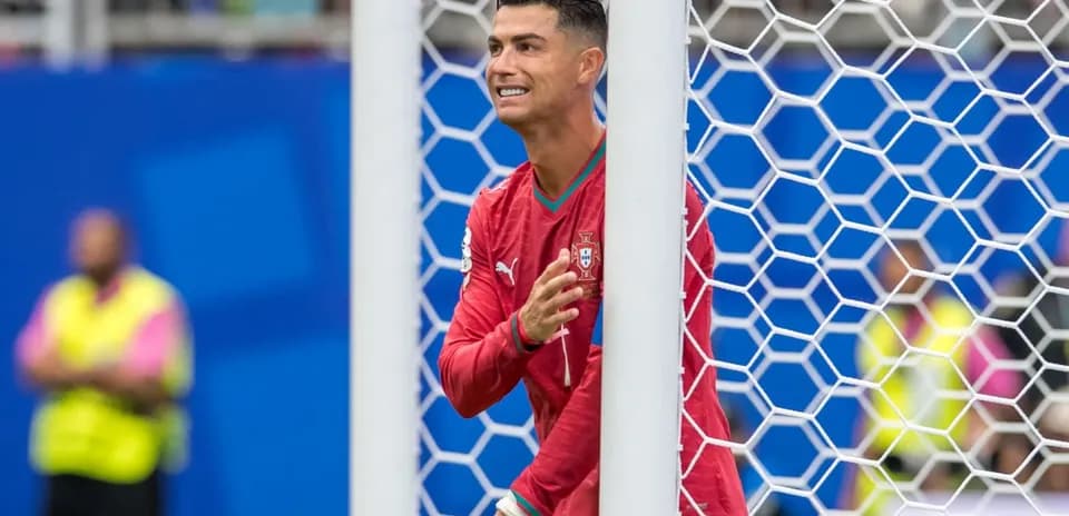 Cristiano Ronaldo celebrating behind goal net