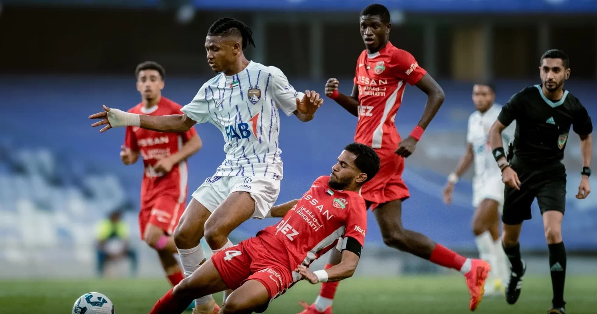 Al Ain U23 player dribbling past Al Sharjah U23 defender