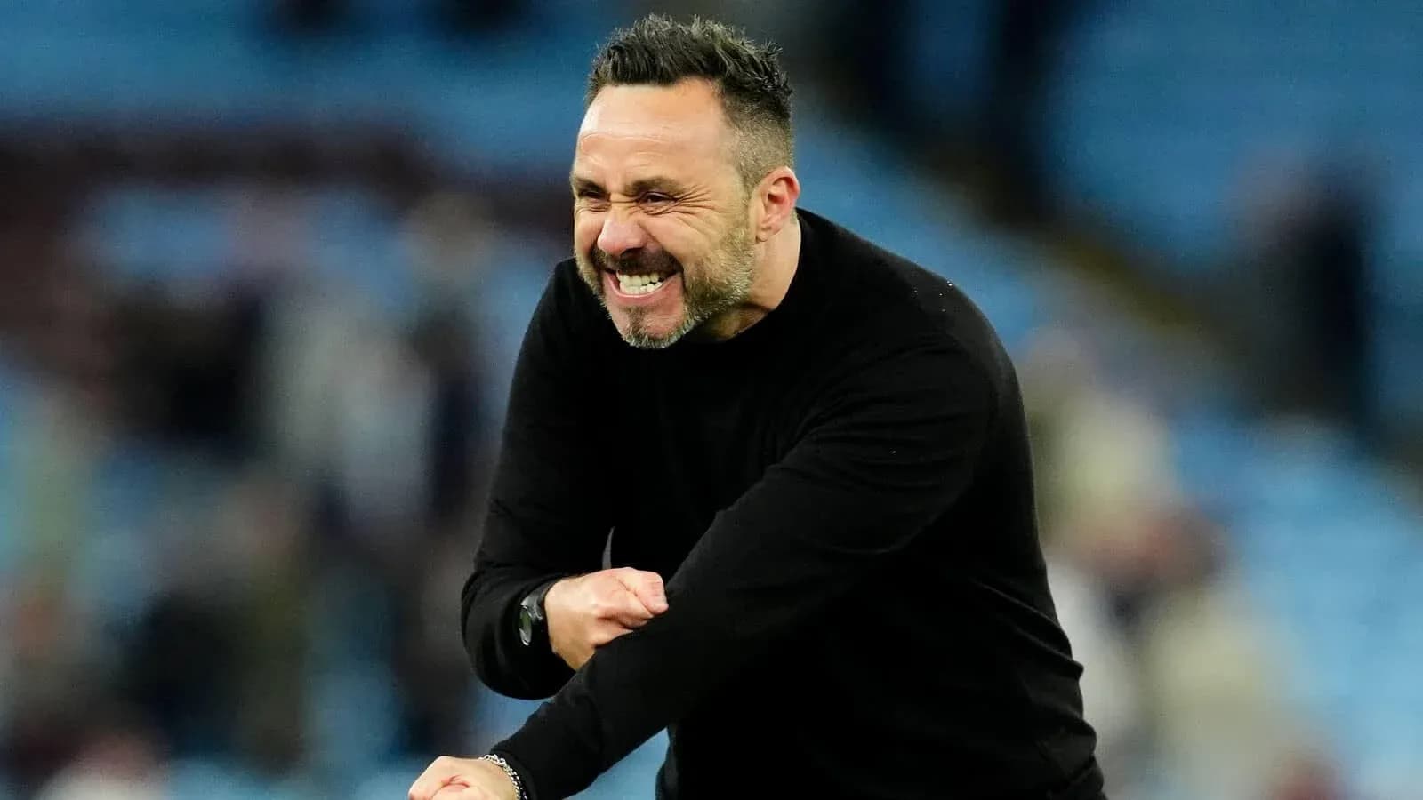 Coach celebrating during a match on the sideline
