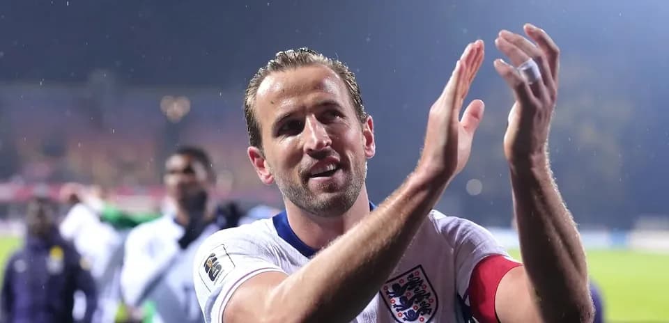 Player applauding fans after match in rain