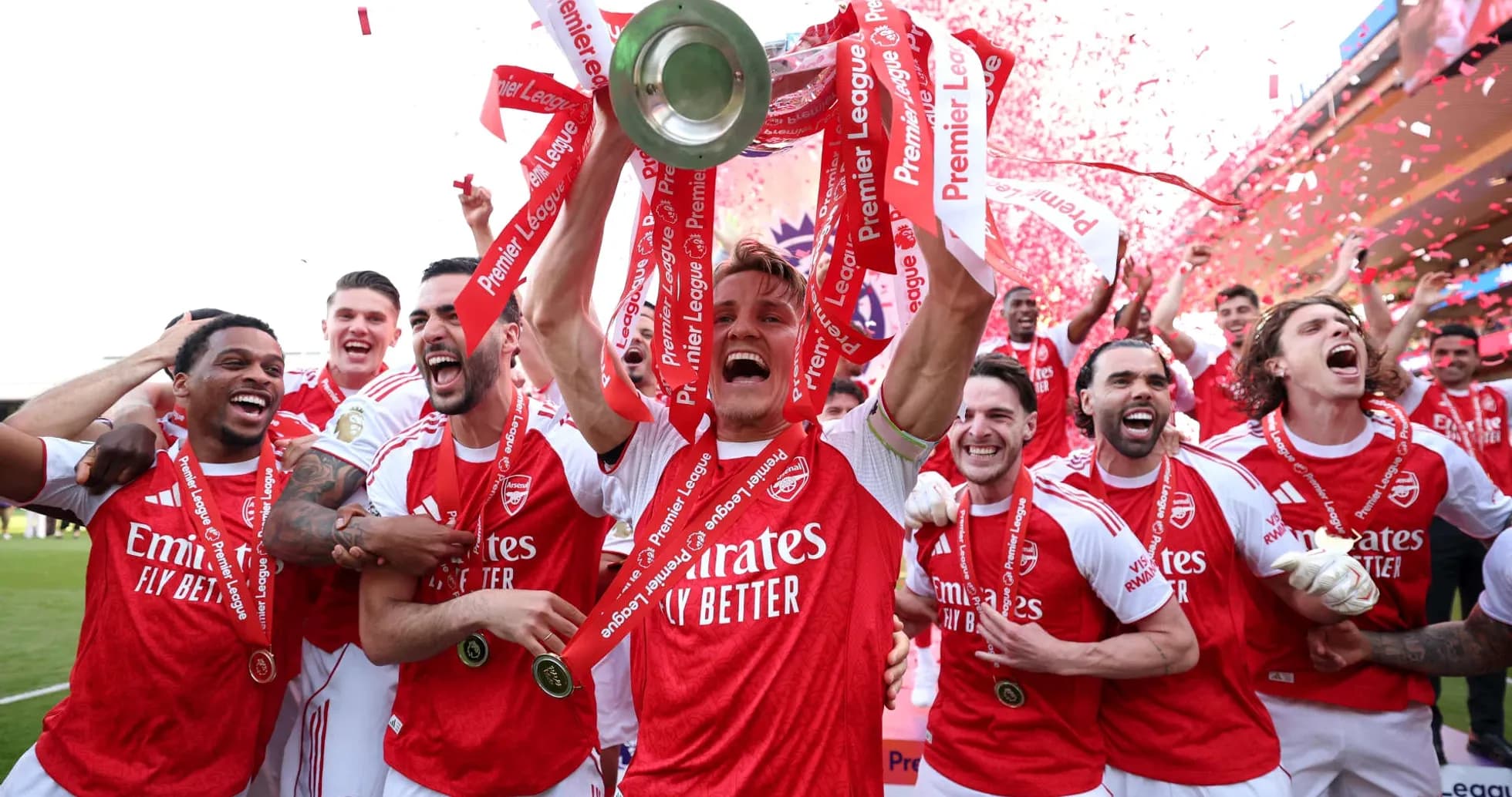Arsenal players celebrating with Premier League trophy