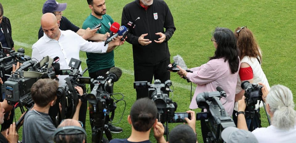 Coach speaking to reporters during press conference