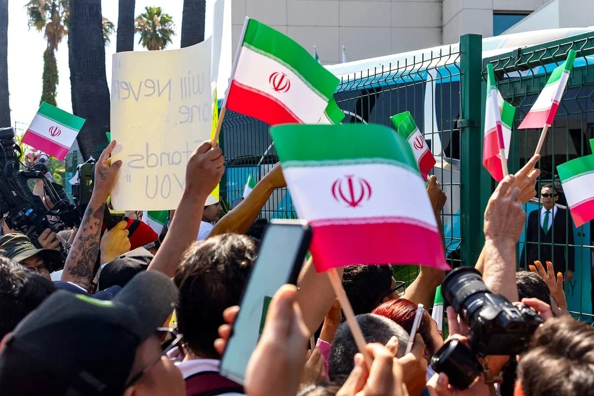 Crowd holding Iranian flags at protest event