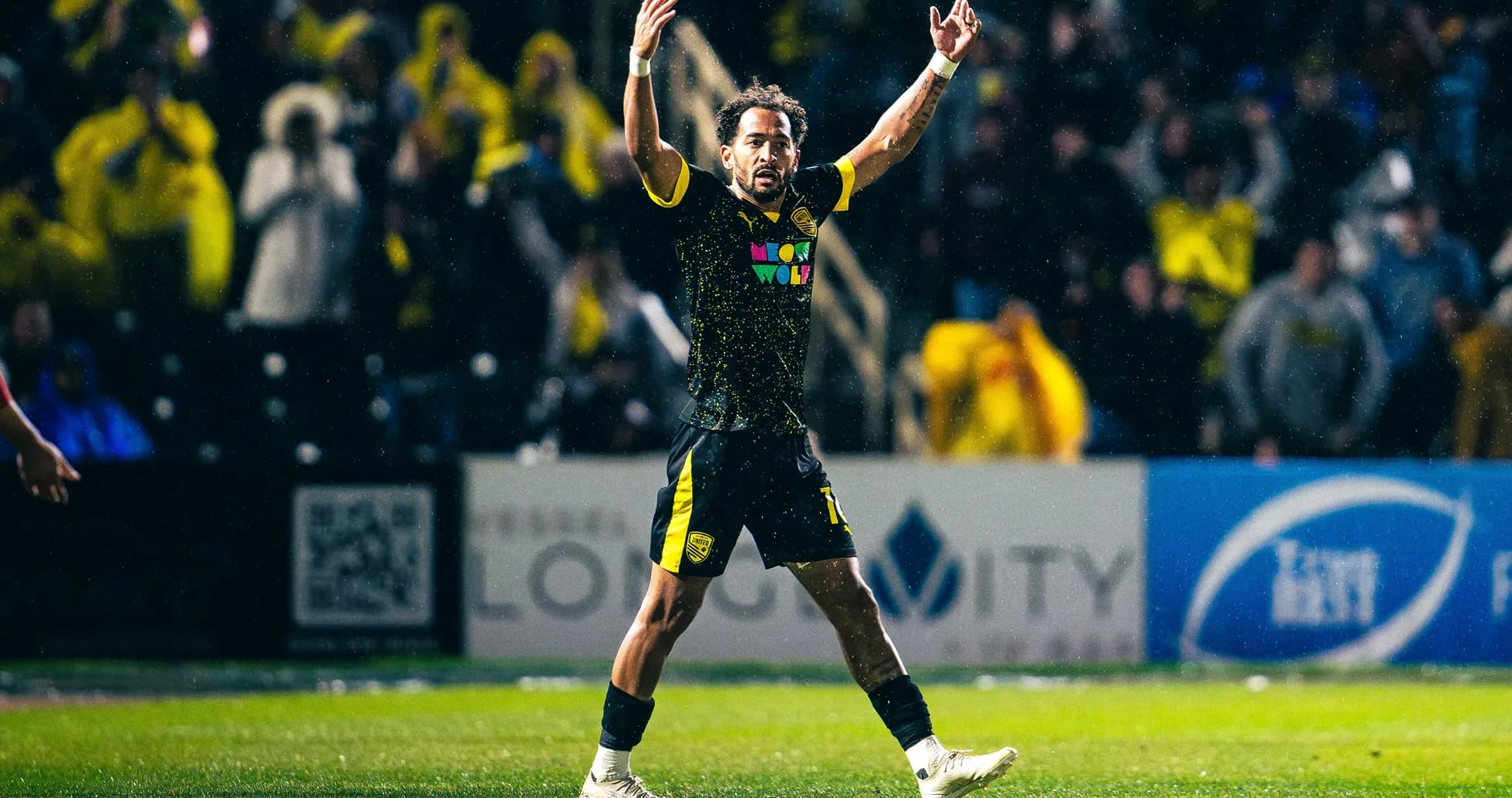 New Mexico United player celebrating in the rain