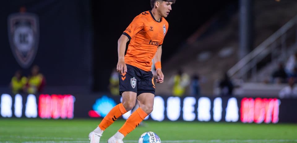 Orange County SC player dribbling the ball