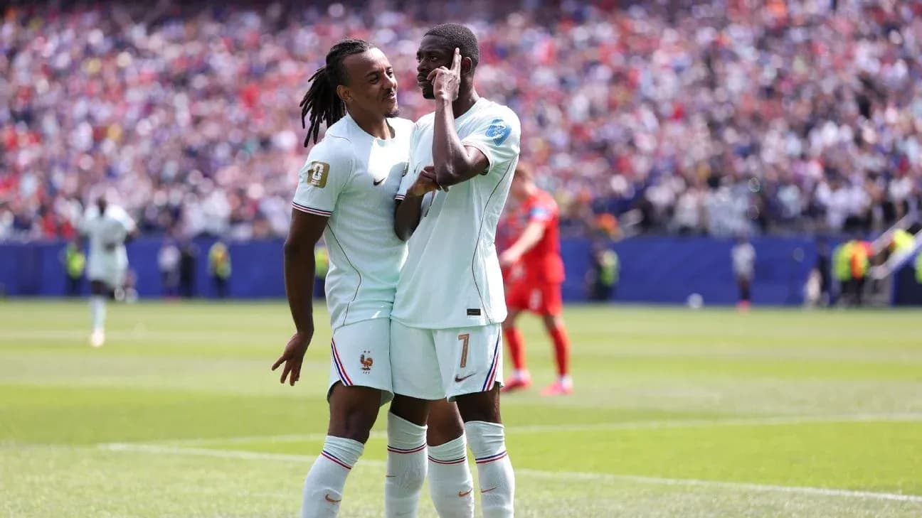 Two French players celebrating a goal on the field