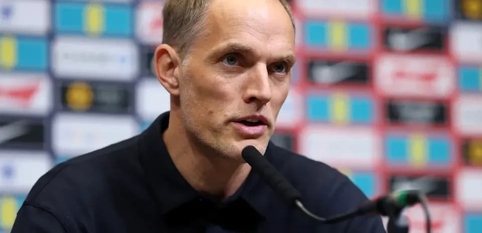 Coach speaking at press conference with microphone