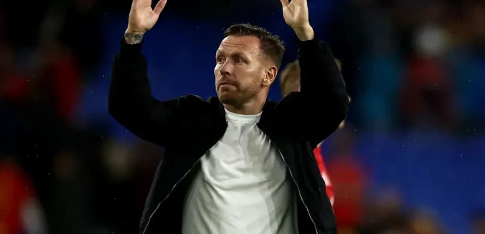 Coach waving to fans after the match