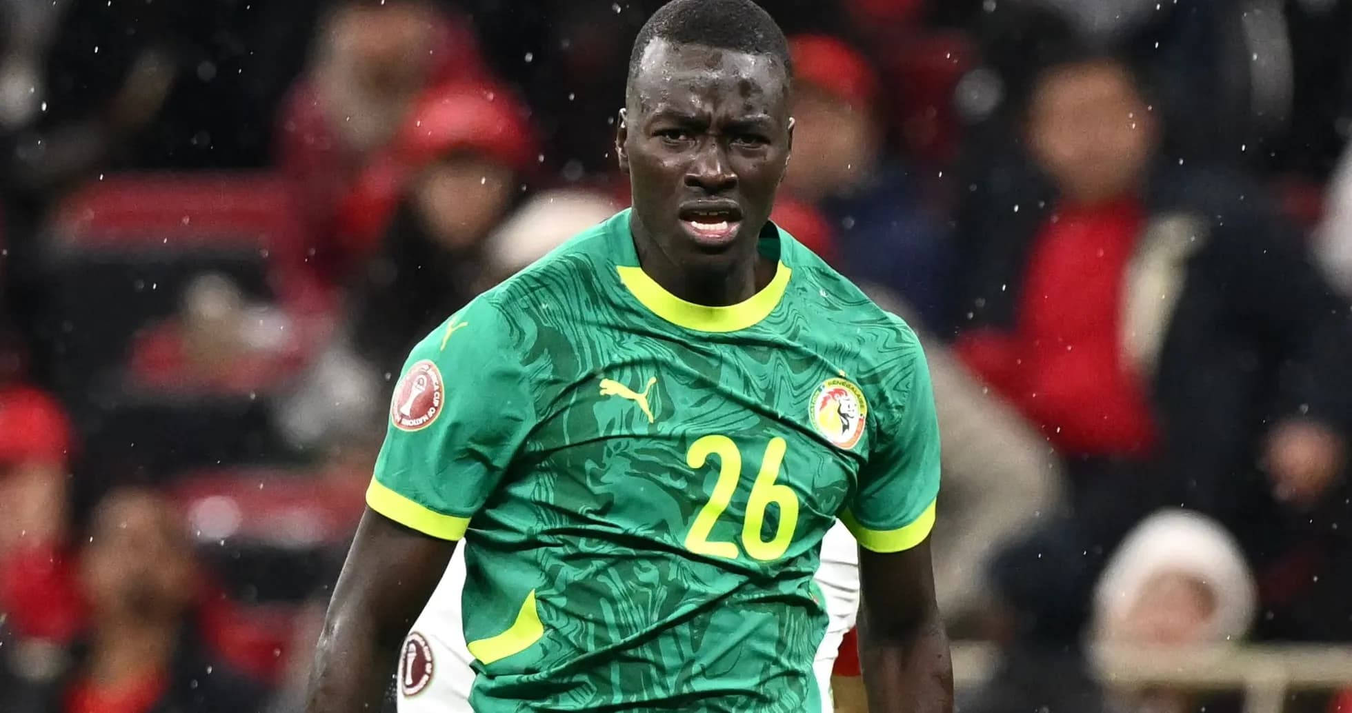 Player in green jersey during football match