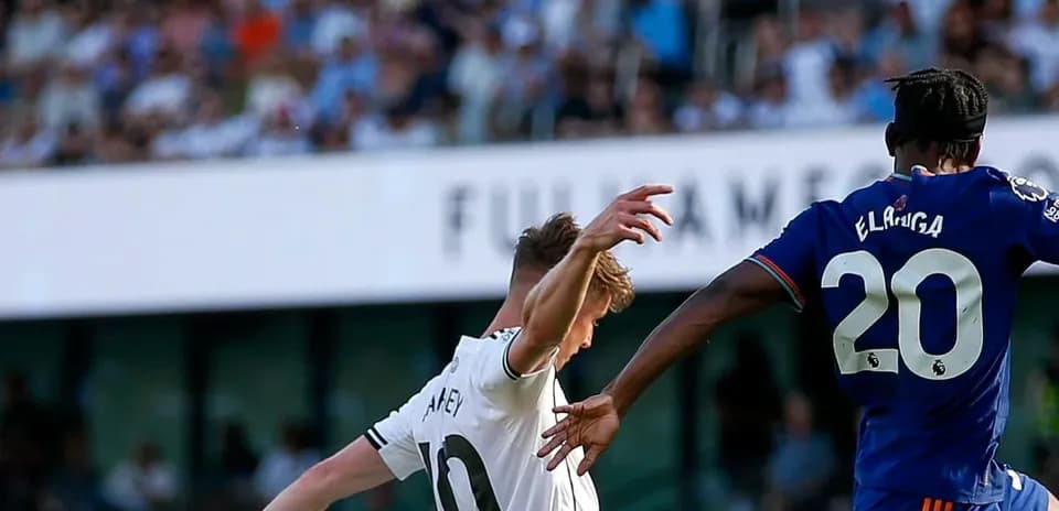 Fulham player challenging Newcastle opponent during match