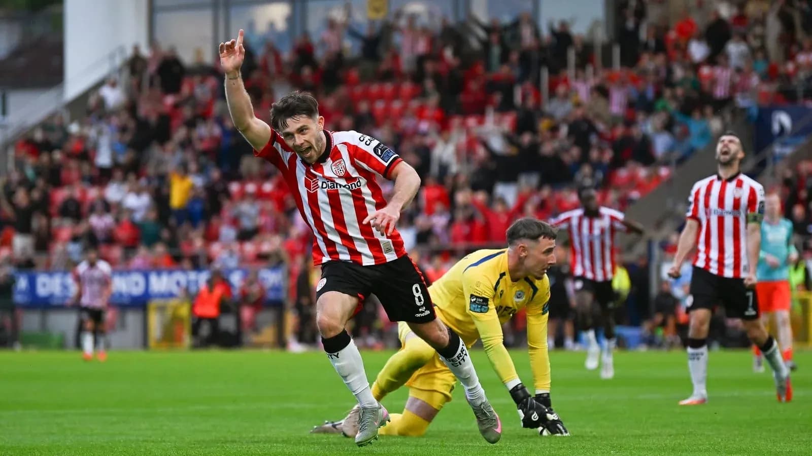 Player celebrating goal with fans in stadium