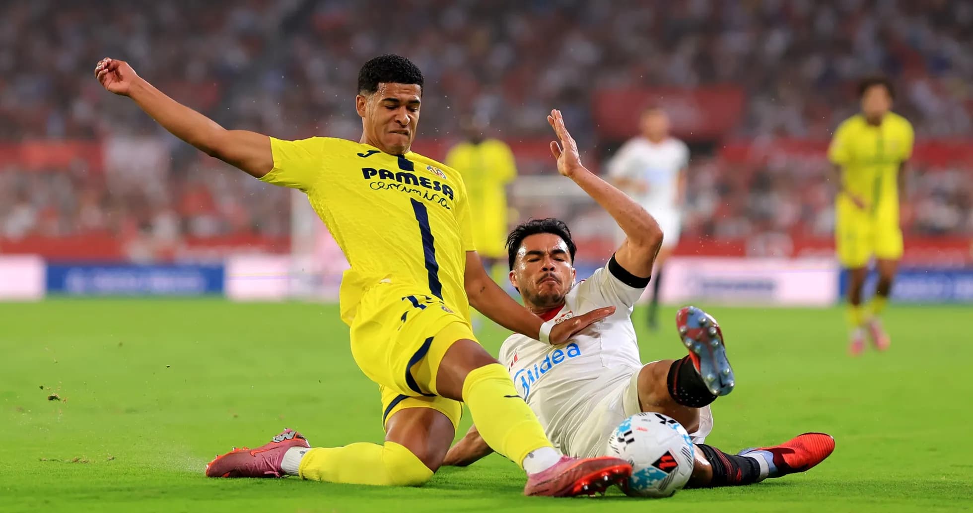 Two players colliding during Villarreal vs Sevilla match