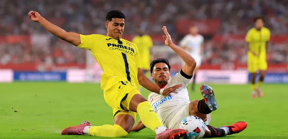 Two players colliding during Villarreal vs Sevilla match