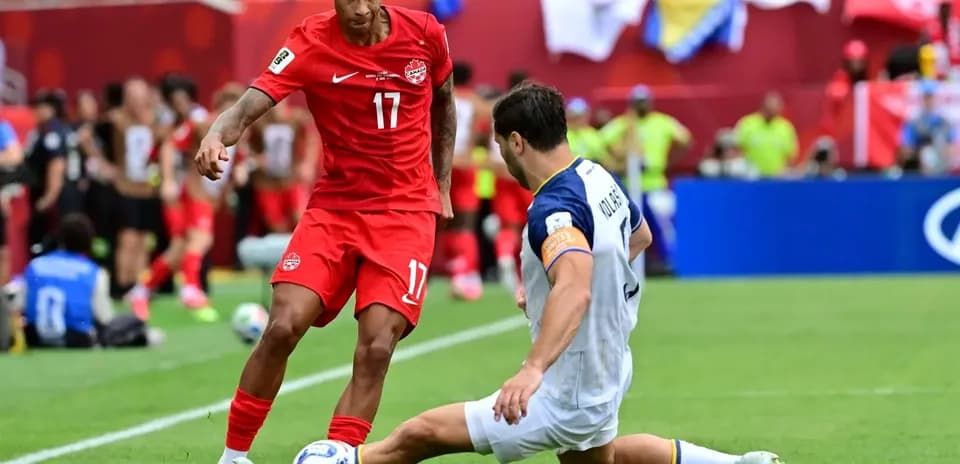 Canada player dribbling against Bosnia defender