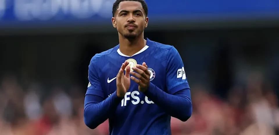 Player applauding fans while wearing blue jersey