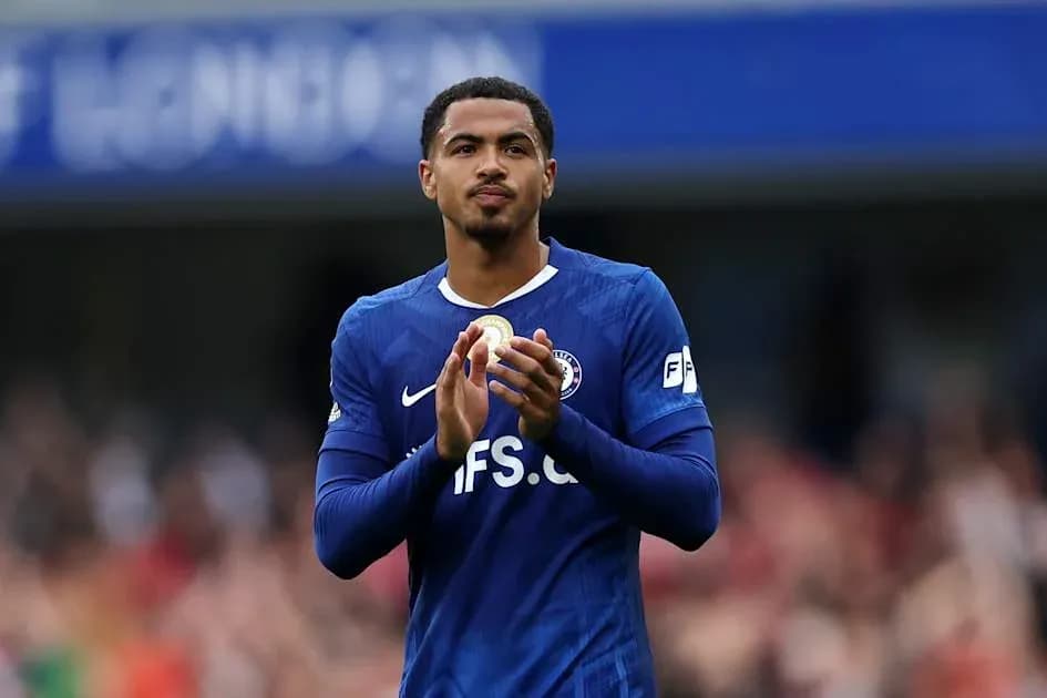 Player applauding fans while wearing blue jersey