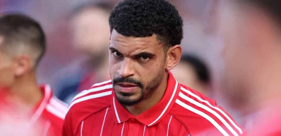 Player in red jersey during pre-match lineup