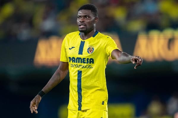 Player in yellow Villarreal kit gesturing on field