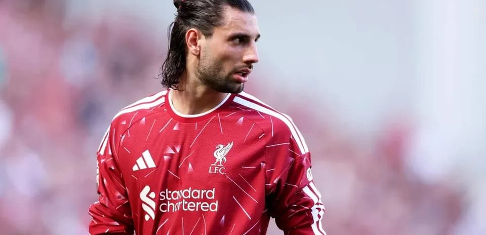 Goalkeeper wearing Liverpool jersey on the pitch