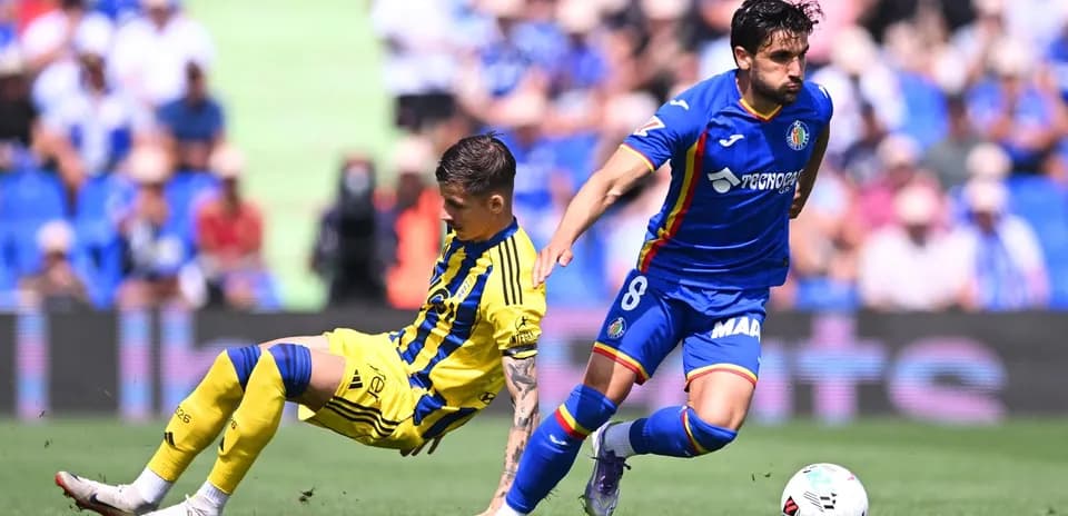 Oviedo player challenged by Getafe opponent