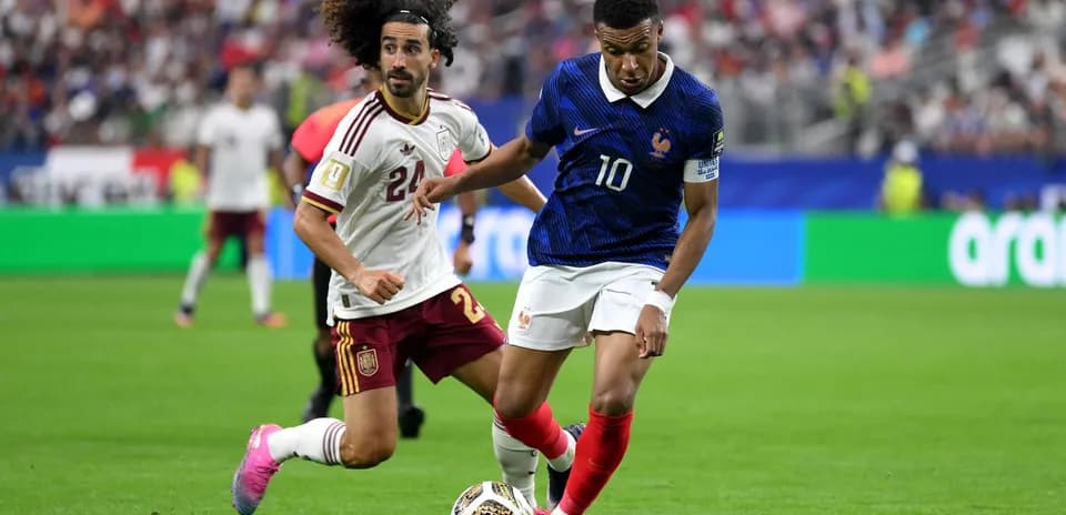 Kylian Mbappe dribbling against Spain player