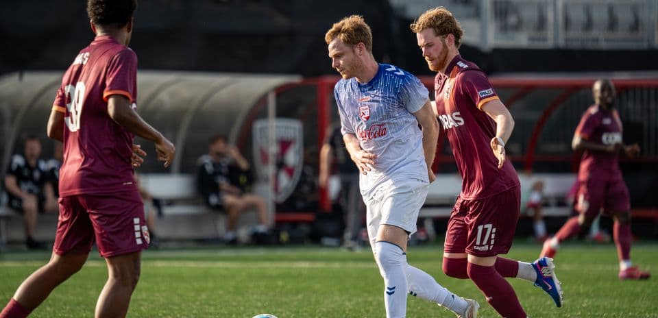 Players competing for the ball during USL match