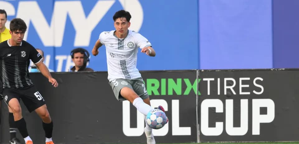 Player dribbling ball in USL Cup match
