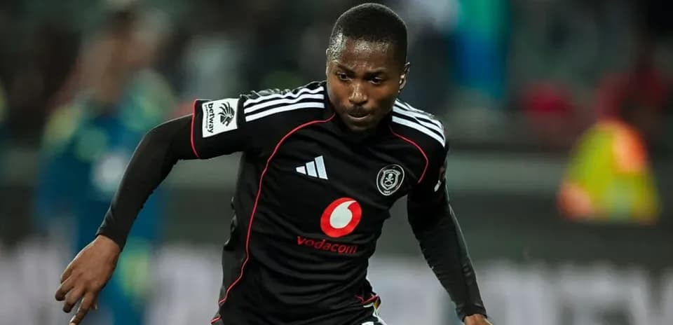 Player in black kit running during a match