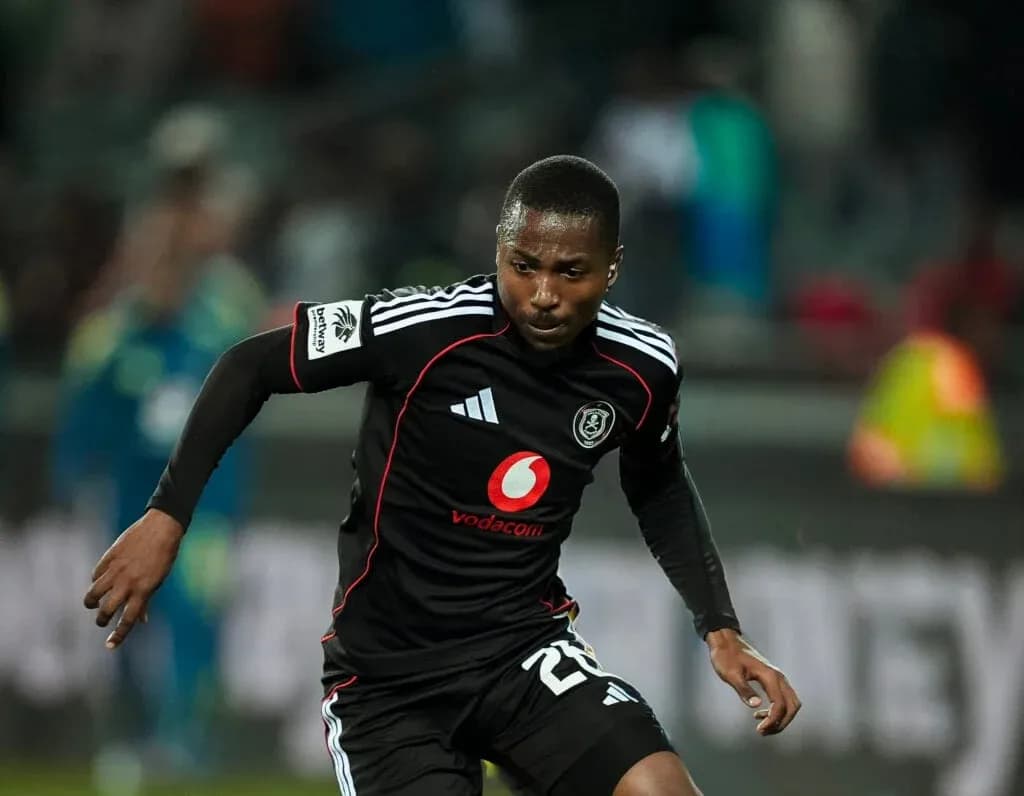 Player in black kit running during a match