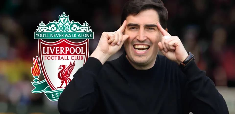 Coach gesturing during Liverpool FC branding backdrop
