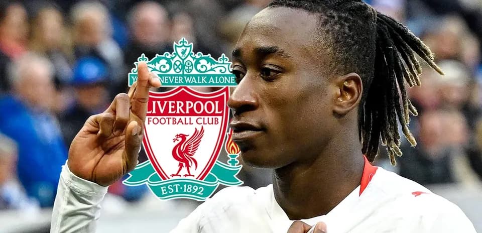 Player celebrating with Liverpool FC logo in background