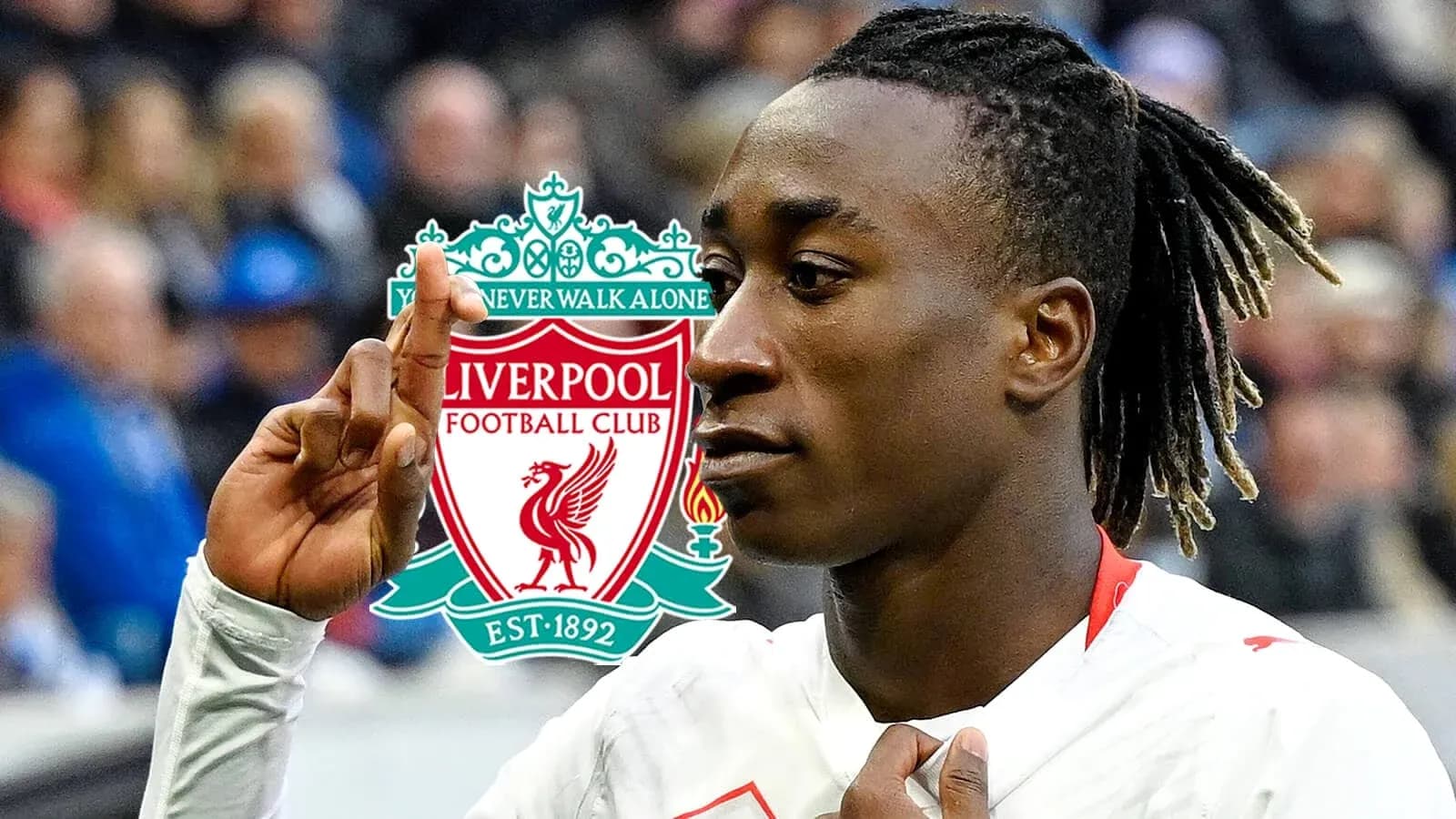 Player celebrating with Liverpool FC logo in background